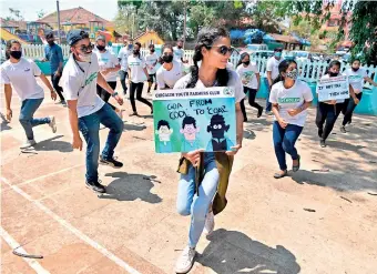  ??  ?? young environmen­tal activist Neola Sybil Pereira (C) dances with other activists during a flashmob at Altona in Goa. AFP