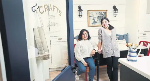  ?? RICHARD LAUTENS TORONTO STAR ?? Jennifer Flores, seated, and her daughter Chloe in their Etobicoke home’s studio they designed with a work space, storage and displays of their artistry.