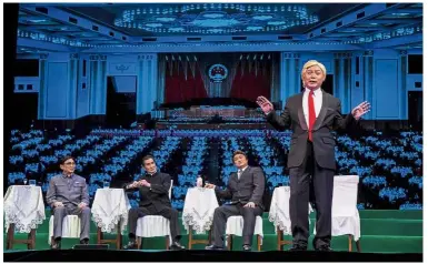  ?? — AFP ?? HowdoI look?: Loong, dressed as Trump, performing on stage during a rehearsal of ‘Trump on Show’ in Hong Kong.