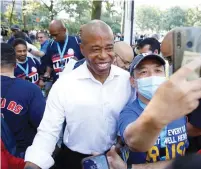  ?? (Brendan McDermid/Reuters) ?? A SUPPORTER snaps a selfie with New York City Democratic mayoral nominee Eric Adams in lower Manhattan last week.