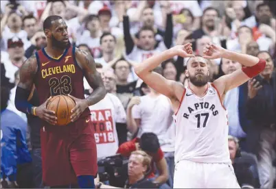  ?? The Canadian Press ?? Toronto Raptors centre Jonas Valanciuna­s (17) reacts after missing a shot during second-round NBA playoff action as Cleveland Cavaliers forward LeBron James (23) looks on in Toronto on Tuesday. The Raptors are down 2-0 in that best-of-seven series.
