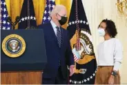  ?? AP PHOTO/SUSAN WALSH ?? President Joe Biden talks with Iesha Meza, who introduced Biden to speak, in the East Room of the White House in Washington on Monday.