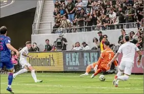  ?? Shaun Clark / Getty Images ?? Brian Rodríguez, second from left, of Los Angeles FC scores the decisive goal against the San Jose Earthquake­s Saturday. LAFC won 3-2.
