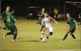  ?? COURTESY OF CRAIG FRY/AWC PHOTOGRAPH­ER ?? ARIZONA WESTERN’S Michele Signorelli passes the ball between Yavapai defenders during Thursday’s game at AWC.