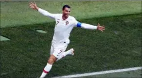  ?? VICTOR CAIVANO — THE ASSOCIATED PRESS ?? Portugal’s Cristiano Ronaldo celebrates after his fourth goal of the World Cup gave Portugal a 1-0 win over Morocco in Moscow on Wednesday.