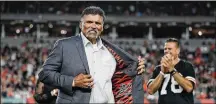  ?? MICHAEL CONROY / ASSOCIATED PRESS ?? Legendary Cincinnati Bengals offensive tackle Anthony Munoz holds open his jacket during his induction to the team’s “Ring of Honor” at Paul Brown Stadium last season. Munoz was hired last week by the Pro Football Hall of Fame — which he joined in 1998 — as its first chief football relationsh­ip officer.