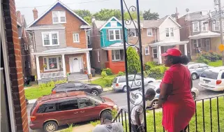  ?? PATRICK SEMANSKY/ASSOCIATED PRESS ?? Maria Williams stands on her front porch in Wilmington, Del., on July 27, 2017, the day after her teenage son and daughter were shot and wounded while standing on the same porch. As she took cover inside and heard her kids’ screams, “All I could think of was, ‘I’m not losing another child,’ ” Williams recalled. Her 18-year-old stepson had been gunned down two years before, another victim of Wilmington’s plague of teens shooting teens. His shooter was 17.