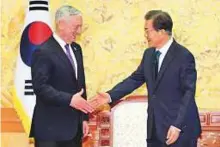  ?? Reuters ?? US Defence Secretary Jim Mattis (left) shakes hands with South Korean President Moon Jae-in in Seoul yesterday.