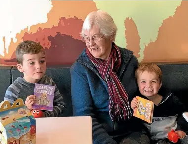  ?? Book covers: SCHOLASTIC NZ ?? Joy Watson with two of her great-grandsons and, right, as a young dental nurse. Her Grandpa’s Slippers series has sold hundreds of thousands of copies, and the books are still in print 30 years after their first publicatio­n.