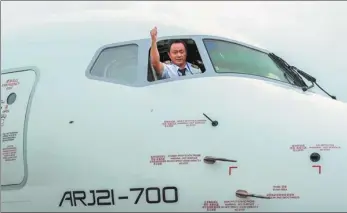  ?? PHOTOS PROVIDED TO CHINA DAILY ?? Zhang Daqi prepares to fly an ARJ21 airplane of One Two Three Airlines in Shanghai.