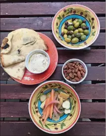  ?? LIGAYA FIGUERAS/LIGAYA.FIGUERAS@AJC.COM ?? The Mezze Mini from Hazel Jane’s is a snack sampler that includes rosemary roasted almonds, citrus marinated olives, pickled vegetables, house-made hummus and flatbread.