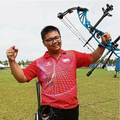  ??  ?? Midas touch: Sabahan Eugenius Lo celebrates after winning the 50m compound archery gold medal in a new Games record yesterday.