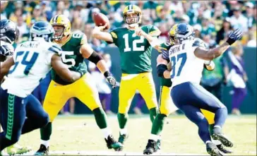  ?? JOE ROBBINS/GETTY IMAGES/AFP ?? The Green Bay Packers’ Aaron Rodgers throws a pass in the first half of their game with the Seattle Seahawks on Sunday at Lambeau Field in Green Bay, Wisconsin.