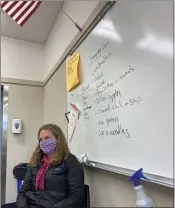  ?? ROBIN EPLEY — ADVOCATE-NEWS ?? Katrina Tichinin sits under a whiteboard with the pantry’s current wishlist of items.