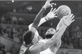  ?? Luis Sinco Los Angeles Times ?? LeBRON JAMES of the Lakers is fouled by the Nuggets’ Torrey Craig during Thursday’s game. James had 28 points, 11 assists and 11 rebounds in the victory.