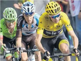  ?? LIONEL BONAVENTUR­E/AFP/GETTY IMAGES ?? Christophe­r Froome emerged from the Alps with the yellow jersey fixed firmly on his shoulders Thursday, fighting of France's Romain Bardet and Colombia's Rigoberto Uran.