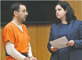  ?? MATTHEW DAE /LANSING STATE JOURNAL VIA AP ?? Former sports doctor Larry Nassar, left, stands with his attorney, Shannon Smith, as he pleads guilty to three counts of first-degree criminal sexual conduct Wednesday in Eaton County, Mich.