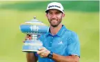  ?? (Reuters) ?? DUSTIN JOHNSON of the United States – the world No. 1 – holds up The Walter Hagen Trophy after beating Jon Rahm of Spain in Sunday’s final round of the World Golf Classic-Match Play tournament at Austin Country Club in Texas.