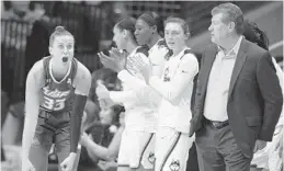  ?? JESSICA HILL/AP ?? South Florida’s Kitija Laksa reacts to a call by an official as Connecticu­t head coach Geno Auriemma, right, looks on during the first half of Monday’s game.