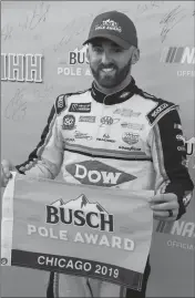  ?? ASSOCIATED PRESS ?? AUSTIN DILLON holds the pole flag after winning the pole for the NASCAR Cup Series auto race at Chicagolan­d Speedway in Joliet, Ill., Saturday.