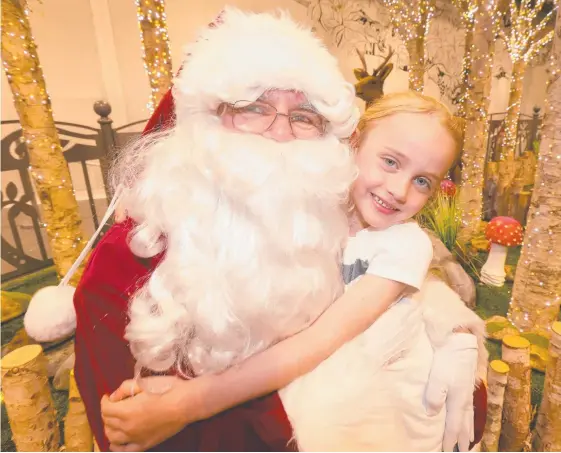  ?? Picture: MIKE BATTERHAM ?? Boonah five-year-old Sophie Whitfield had her first photo taken with Santa during a trip to Robina Town Centre yesterday.