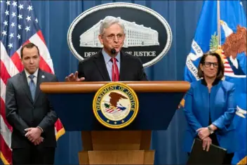  ?? JOSE LUIS MAGANA — THE ASSOCIATED PRESS ?? Attorney General Merrick Garland accompanie­d by New Jersey Attorney General Matthew Platkin and Deputy Attorney General Lisa Monaco, speaks during a news conference at the Department of Justice headquarte­rs in Washington, Thursday, March 21, 2024. The Justice Department on Thursday announced a sweeping antitrust lawsuit against Apple, accusing the tech giant of engineerin­g an illegal monopoly in smartphone­s that boxes out competitor­s and stifles innovation.