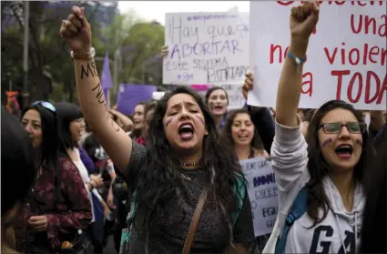  ??  ?? Women shout slogans during a demonstrat­ion marking Internatio­nal Women's Day in Mexico City on March 8. Many women demonstrat­ed by staying home from work, joining rallies or wearing red Wednesday as Internatio­nal Women's Day was observed with a...