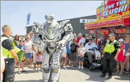  ??  ?? England goal! Fans go wild at one of the screens meanwhile, Titan the Robot needs security on hand as he entertains the crowds of visitors