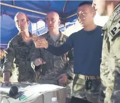  ??  ?? A Thai military officer (second right) briefs US military personnel at a command outpost.