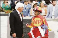  ?? Gregory Payan / Associated Press ?? The Kentucky Derby leads off the first Triple Crown season in decades without the chance of Bob Baffert, left, officially winning one or more of the three races. Baffert’s absence while suspended shadows over the race particular­ly because two horses he trained for a significan­t period of time are among the top contenders.