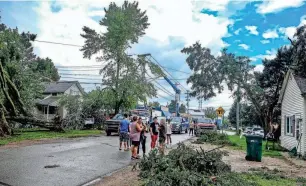  ?? PHOTOS BY ROBERT KILLIPS/LANSING STATE JOURNAL ?? Residents of Perry watch as tornado damage is cleared Saturday.