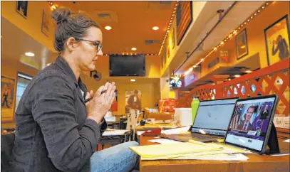  ?? Rich Pedroncell­i The Associated Press ?? Sharlene Katz, who with her husband owns the Dancing Tomato Caffe in Yuba City, clasped her hands Tuesday in the hope that Sutter County would be one of two counties in which California Gov. Gavin Newsom would allow restaurant­s to reopen. It wasn’t.