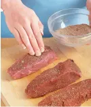  ??  ?? Rub all sides of the steaks with the Cajun spice mix. Press it into the meat to help the spices adhere.