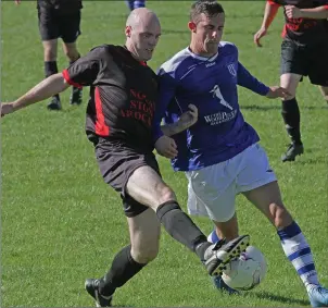  ??  ?? Colin Redmond of Bridge Rovers and Danny Byrne of Ashford Rovers battle for the ball.