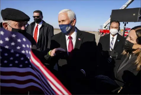  ?? Michael Conroy/Associated Press ?? Former Vice President Mike Pence greets supporters Jan. 20 after arriving back in his hometown of Columbus, Ind. Since leaving office, Mr. Pence, who was Indiana’s governor and a member of Congress before he was vice president, has kept a somewhat low profile. He has pieced together a portfolio aimed at maintainin­g influence and paying the bills and is eyeing a potential run for the White House in 2024.