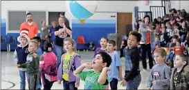  ??  ?? ABOVE: Model first-graders play in a volleyball game against teachers and staff.
LEFT: Shelley Robbins (from left), Aimee Hays and Laura Fincher playfully trash talk second-graders during a game.
BELOW: Parapro Christine Fisher plays in a student vs....