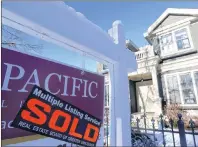  ?? JONATHAN HAYWARD/CANADIAN PRESS PHOTO ?? A real estate sold sign is shown outside a house in Vancouver, Tuesday, Jan.3, 2017. The Real Estate Board of Greater Vancouver says home sales across Metro Vancouver were steady but more “historical­ly normal” in 2017, although prices continued to climb.