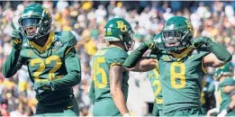  ?? SAM HODDE/AP ?? Baylor safety JT Woods (22) and teammate safety Jalen Pitre (8) celebrate after making a stop against Texas on Saturday in Waco, Texas.