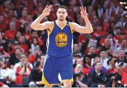  ??  ?? Golden State Warriors guard Klay Thompson reacts after making a 3-pointer during the second half of Saturday night’s playoff game against the Portland Trail Blazers in Portland, Ore.