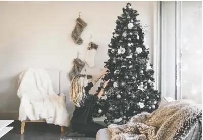  ?? ANTHONY TROMBETTA ?? Kara Trombetta, a photograph­er based in Austin, Texas, has had a matte black Christmas tree for several years, she says.