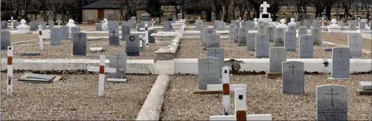  ?? MATTHEW LIEBENBERG/SOUTHWEST BOOSTER ?? Above: The veterans plot in Swift Current’s Mount Pleasant Cemetery. Below: The white wooden cross marks the grave of Rifleman Denis Celestin Denniel in Swift Current. In the background are previously installed permanent granite headstones for veterans.