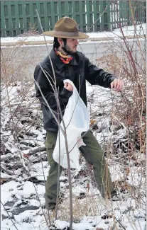  ?? BILL JONES/DAILY SOUTHTOWN PHOTOS ?? Shane Skeffingto­n, of Boy Scout Troop 619, pushes his way past some branches and tall grass to get to more garbage near the Sand Ridge Nature Center on Monday.