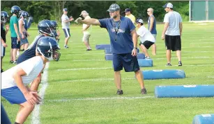  ?? Photo by Ernest A. Brown ?? Burrillvil­le coach Gennaro Ferraro (center) loved last season’s Super Bowl champion squad, but he’s turned the page and is ready for the start of this season Saturday at Alumni Field.