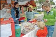  ??  ?? Hilltown 4-H members raise funds at their bake sale table at Perkasie Fall Fesitival.