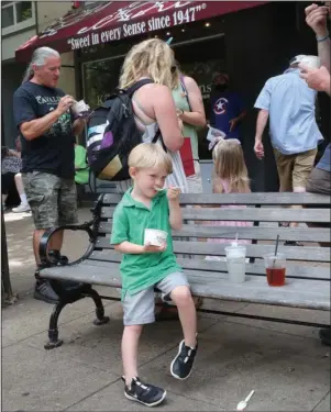  ?? The Sentinel-Record/Richard Rasmussen ?? ICE CREAM BREAK: Oliver Guffey, 4, and other members of his Dyersburg, Tenn., family enjoy some ice cream they purchased from Kilwins in the 200 block of Central Avenue Monday.