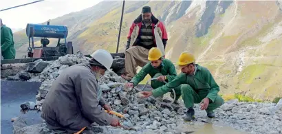  ?? AFP ?? Labourers wash pieces of rocks outside a mine on a mountain to find gemstones in Chitta Katha, Azad Kashmir. —