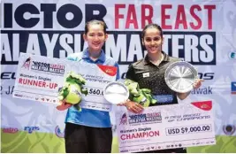  ?? PIC/PTI ?? Champion Saina Nehwal (right) and runner-up Pornpawee Chochuwong of Thailand pose with their trophies after the women's singles final match of Malaysia Masters tournament in Sarawak, Malaysia on Sunday