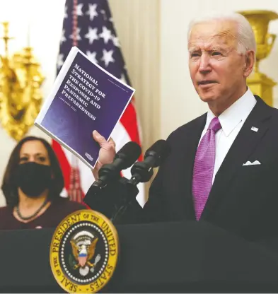  ?? ALEX WONG / GETTY IMAGES ?? U.S. President Joe Biden, with Vice President Kamala Harris, has ordered that masks be worn on many planes and other modes of transporta­tion, although some specifics, including how the order might be enforced, remain unclear.