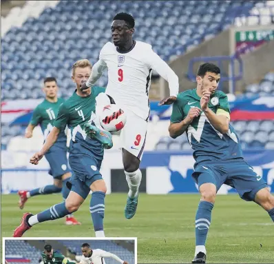  ?? PICTURES: MARTIN RICKETT/PA ?? MY BALL: Slovenia’s Benjamin Markus and Dusan Stojinovic battle for the ball with England’s Folarin Balogun during the UEFA European U21 Championsh­ip qualifying match at the John Smith’s Stadium. Inset, Cameron Archer scores for England.