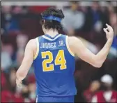  ?? Associated Press ?? UCLA guard Jaime Jaquez Jr. reacts after scoring a 3-pointer against Stanford during the first half on Thursday in Stanford. Jaquez scored 27 points in the Bruins’ 80-66 victory.